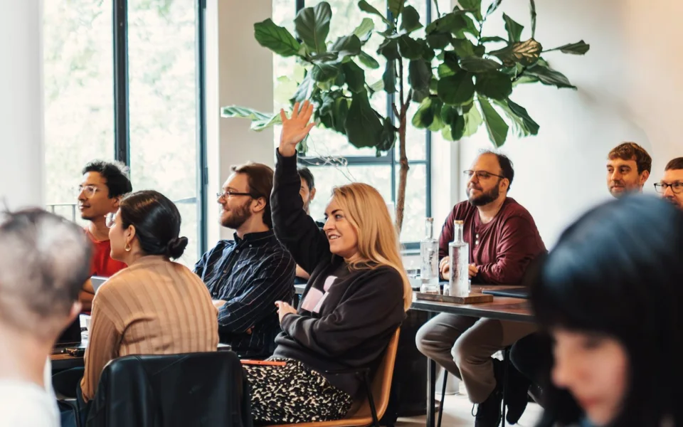 Participants raising hands during a Foundations Day
